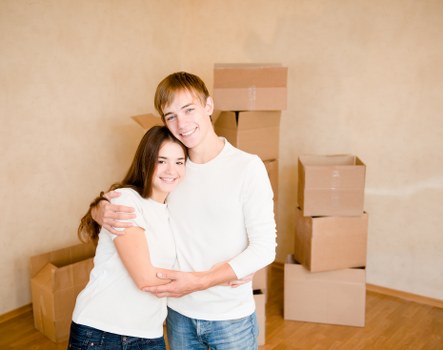 Two workers using correct manual handling techniques with furniture