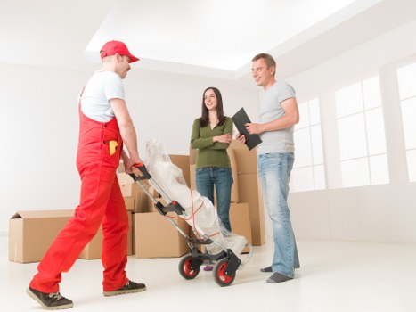 Packed moving boxes and protected furniture ready for transport