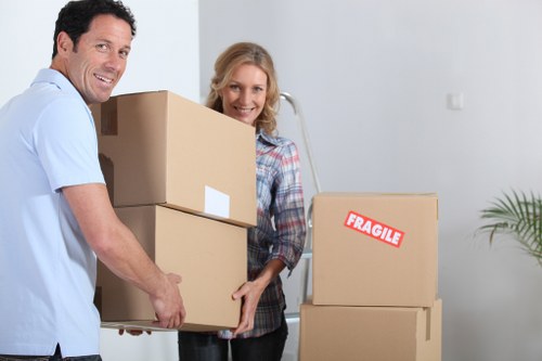 Removal crew handling furniture and boxes for a home move in North London
